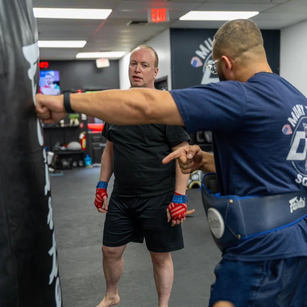 Coach working one on one with an adult beginner