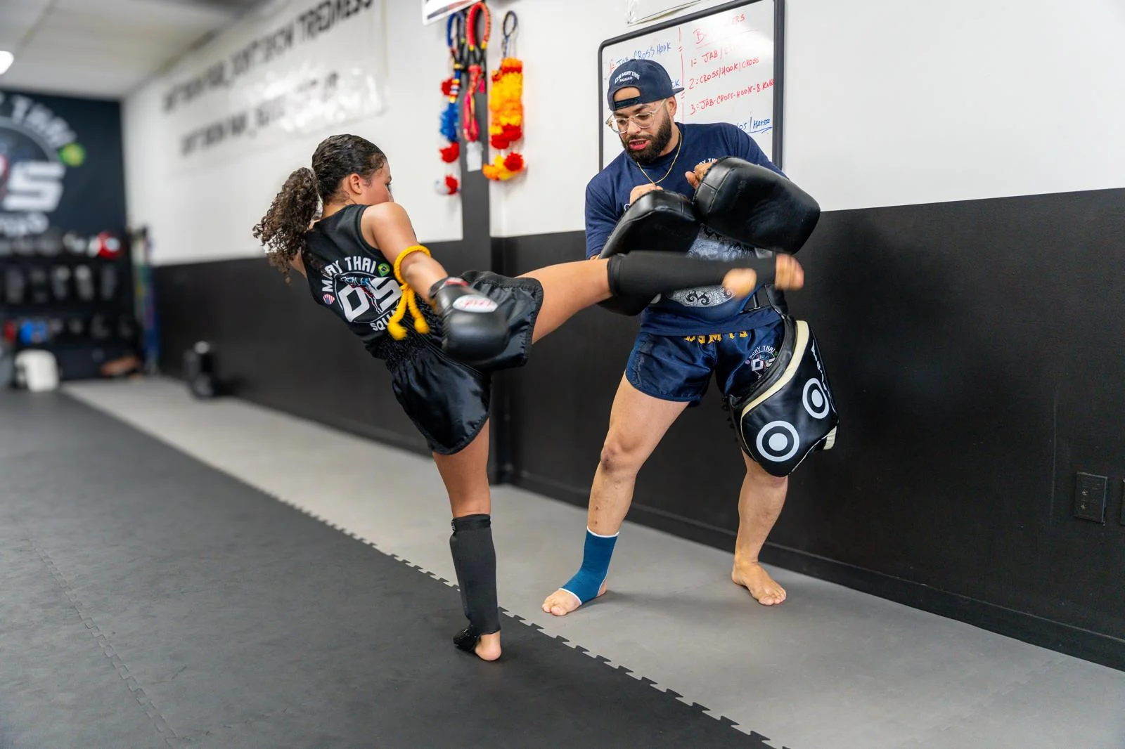 Woman training kicks on the pads