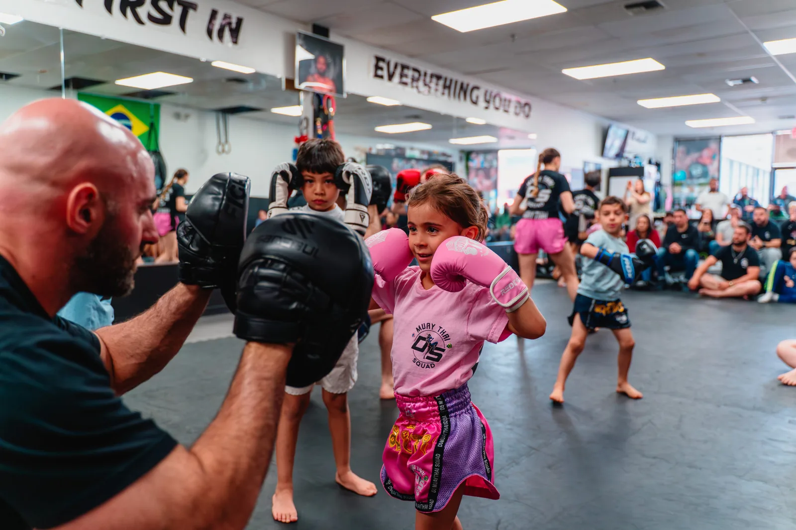 Coach holding pads for a young student